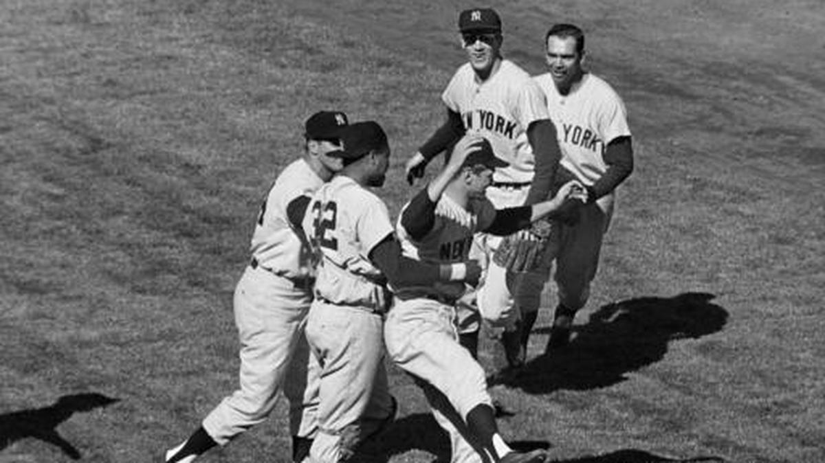 FILE - In this Oct. 16, 1962, file photo, New York Yankees players celebrate at Candlestick Park, after defeating the San Francisco Giants 1-0 in Game 7 of the baseball World Series. In group at center, first baseman Bill Skowron, left, and catcher Elston Howard (32) rush winning pitcher Ralph Terry. In the background are shortstop Tony Kubek, left, and second baseman Bobby Richardson. Richardson was was with the Yankees at the tail end of what is generally viewed as the greatest dynasty of them all--a 44-year stretch that, beginning in 1921, produced 20 World Series titles, 29 American League pennants, 43 winning seasons and only two finishes lower than third in the AL standings. Over his first eight full seasons with the Yankees, he went to the World Series seven times.