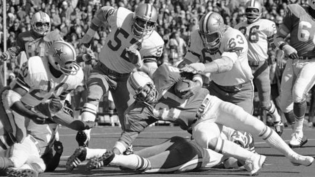 FILE - In this Jan. 16, 1972 file photo, Miami running back Jim Kiick (21) is brought down by Dallas tacklers after picking up a short game during first quarter of the Super Bowl football game in New Orleans. Also shown are Dallas Cowboys players Dave Edwards (52), Larry Cole (63) and Herb Adderley (26). Former Dallas Cowboys linebacker Dave Edwards has died. He was 76. Edwards’ brother, Tim Edwards, tells The Associated Press that Dave Edwards died in his sleep Monday night, Dec. 5, 2016, at his home near Lake Whitney, Texas, about 65 miles south of Dallas.