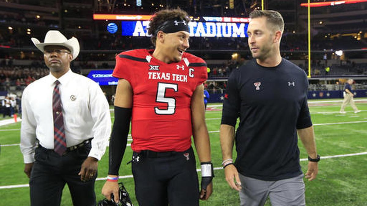 Texas Tech quarterback Patrick Mahomes II, center, and Tech head coach Kliff Kingsbury, right, walk off the playing field defeating Baylor in an NCAA college football game Friday, Nov. 25, 2016, in Arlington, Texas.